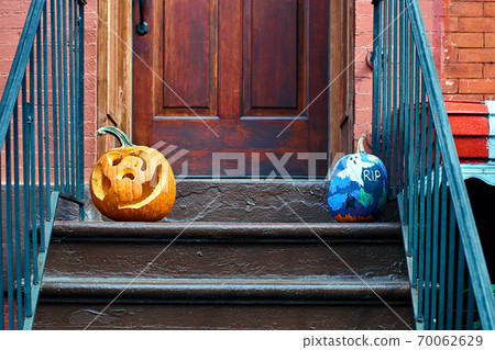 Carved Halloween pumpkins or jack o'lantern on the doorstep in Brooklyn Carved Halloween pumpkins or jack o'lantern on the doorstep in Brooklyn 70062629