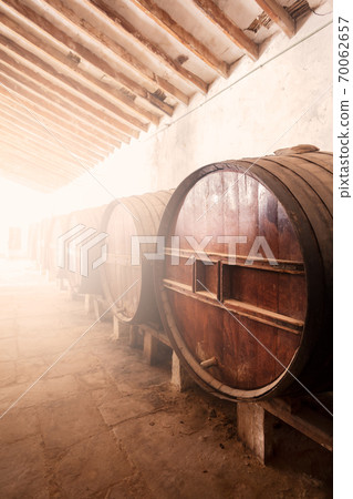 Wine barrels stacked in the old cellar of the vinery in Spain Wine barrels stacked in the old cellar of the vinery in Spain 70062657