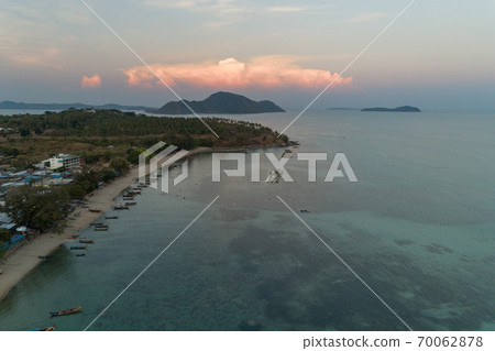 Aerial view drone shot of long tail boats at rawai beach in phuket Thailand sunset evening time. Aerial view drone shot of long tail boats at rawai beach in phuket Thailand sunset evening time. 70062878