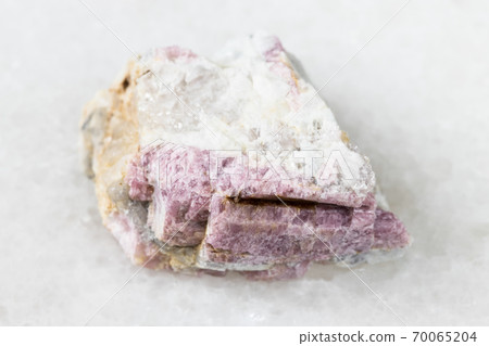 raw pink Tourmaline in feldspar on white marble raw pink Tourmaline in feldspar on white marble 70065204