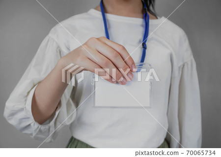 Woman showing a blank ID card 70065734