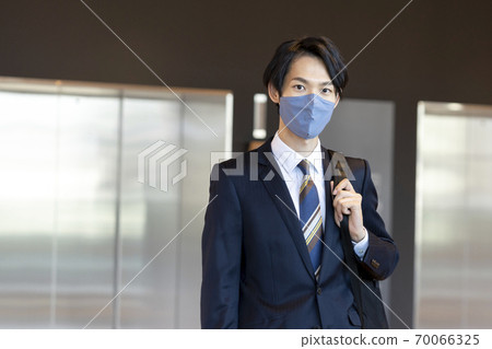 Young businessman wearing a mask Young businessman wearing a mask 70066325