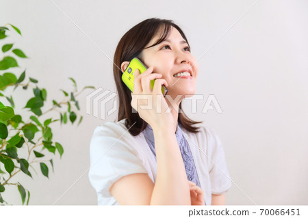 A woman talking on a smartphone A woman talking on a smartphone 70066451