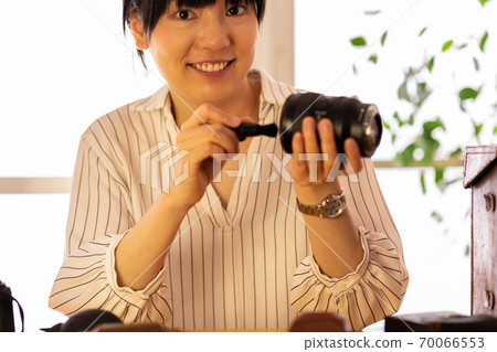 Female camera maintenance cleaning 70066553