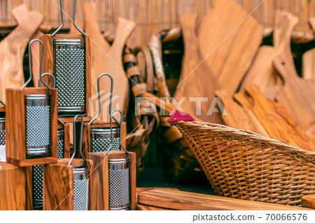 Wooden kitchen utensils. Wooden grater and other wooden tools for the kitchen in the background. Wooden kitchen utensils. Wooden grater and other wooden tools for the kitchen in the background. 70066576
