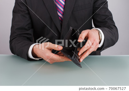 Business person holding an empty wallet. Business person holding an empty wallet. 70067527