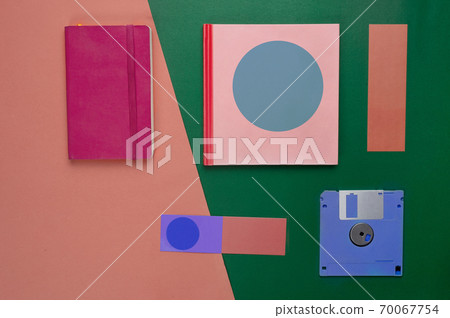 pink red notebook paper and blue diskette in retro or vintage style business green orange background pink red notebook paper and blue diskette in retro or vintage style business green orange background 70067754