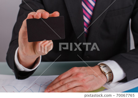 Close up businessman hand showing business card. 70067765