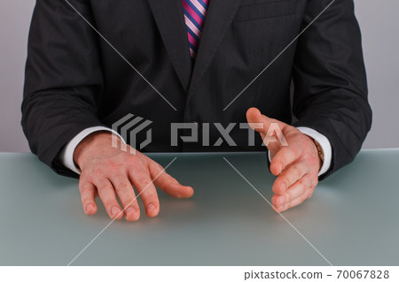Confident businessman sitting at table. Confident businessman sitting at table. 70067828