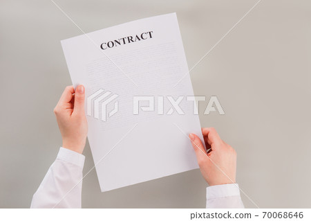 Female hands holding contract letter. 70068646