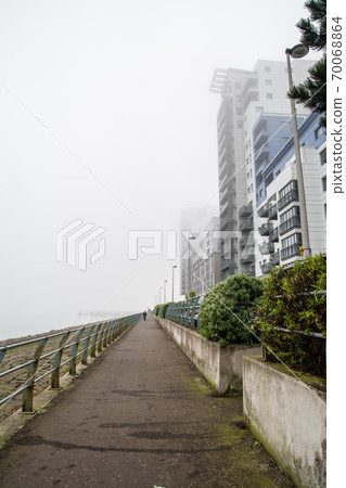 A group of modern condominiums built in the haze of a cloudy sky in the suburbs of Edinburgh A group of modern condominiums built in the haze of a cloudy sky in the suburbs of Edinburgh 70068864