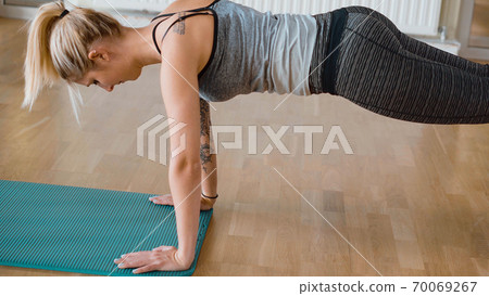 Sporty woman doing fitness training at a gym 70069267