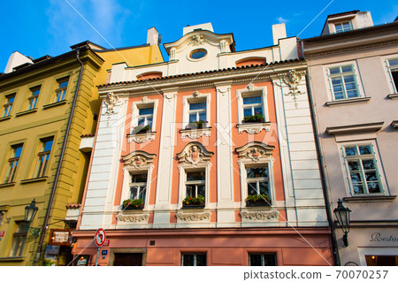 The architecture of the strago city of Prague. Multi-colored low buildings and stone paving stones. Streets of old Europe The architecture of the strago city of Prague. Multi-colored low buildings and stone paving stones. Streets of old Europe 70070257