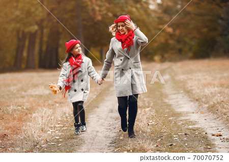 Cute and stylish family in a autumn park 70070752