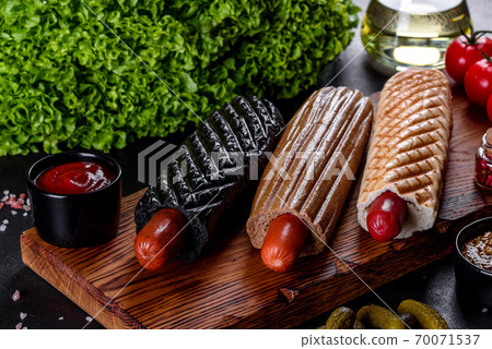 Delicious fresh hot hotdogs with various kinds of buns and sausages. 70071537