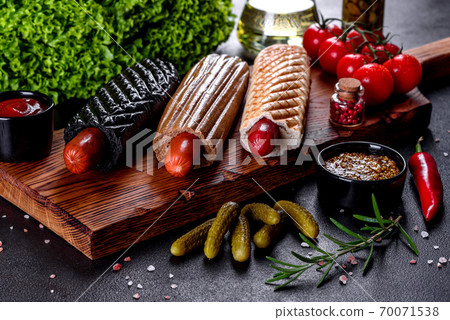 Delicious fresh hot hotdogs with various kinds of buns and sausages. 70071538