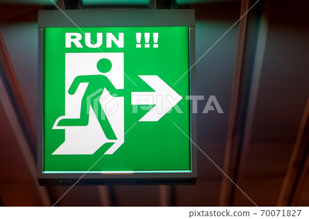 The emergency exit sign RUN! shows the direction of escape in case of danger.  70071827