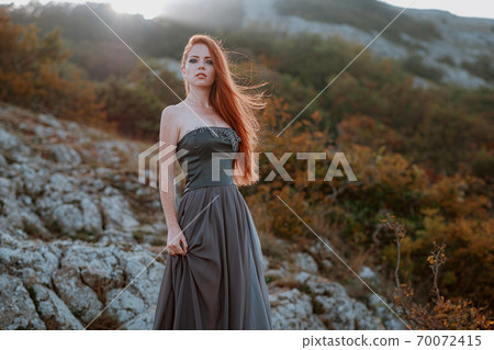 beautiful furious scandinavian warrior ginger woman in grey dress 70072415