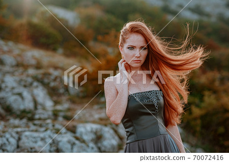 beautiful furious scandinavian warrior ginger woman in grey dress 70072416