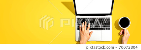 Person using a laptop computer 70072804