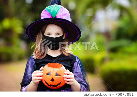 Kids trick or treat. Halloween in face mask. 70073091