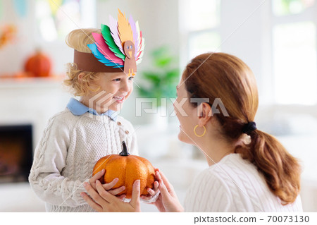 Child on Thanksgiving. Kid with autumn turkey hat. Child on Thanksgiving. Kid with autumn turkey hat. 70073130
