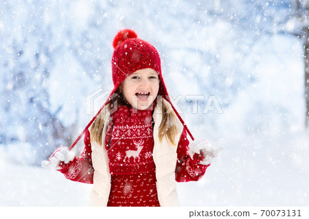 Child playing in snow on Christmas. Kids in winter Child playing in snow on Christmas. Kids in winter 70073131