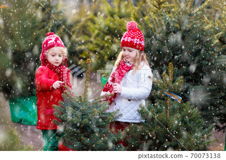 Kids buying Christmas tree Kids buying Christmas tree 70073138