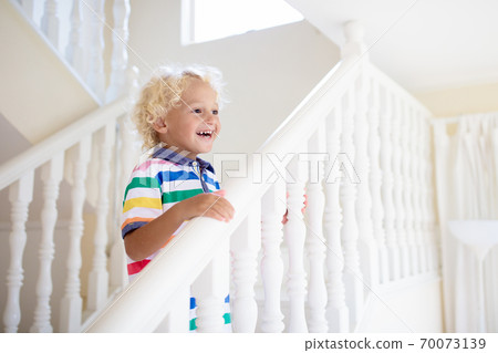 Kids on stairs. Child moving into new home. Kids on stairs. Child moving into new home. 70073139