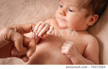 Portrait of a baby boy on a beige background. Portrait of a baby boy on a beige background. 70073864