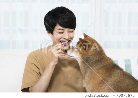 Young men and dogs 70075673