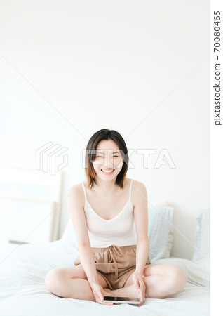 Young beautiful oriental young women at home daily Young beautiful oriental young women at home daily 70080465