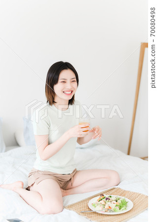 Young beautiful oriental young women at home daily Young beautiful oriental young women at home daily 70080498