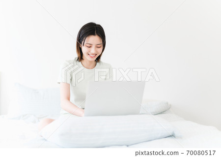 Young beautiful oriental young women at home daily Young beautiful oriental young women at home daily 70080517