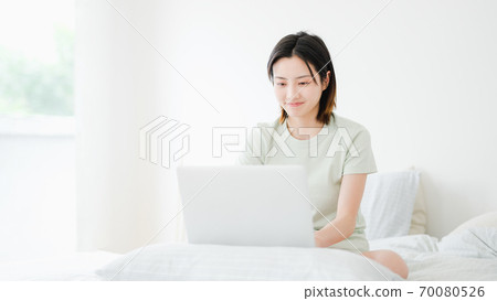 Young beautiful oriental young women at home daily 70080526
