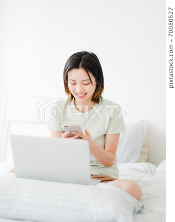 Young beautiful oriental young women at home daily 70080527