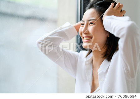 Young beautiful oriental young women at home daily 70080684