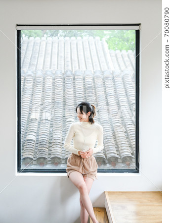 Young beautiful oriental young women at home daily Young beautiful oriental young women at home daily 70080790