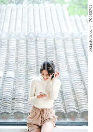 Young beautiful oriental young women at home daily Young beautiful oriental young women at home daily 70080792