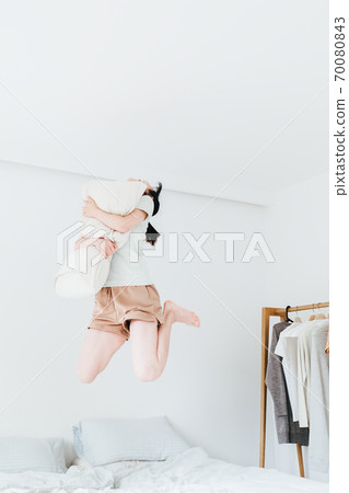 Young beautiful oriental young women at home daily Young beautiful oriental young women at home daily 70080843