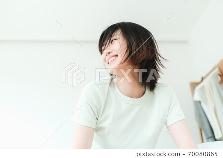 Young beautiful oriental young women at home daily 70080865