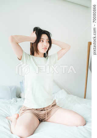 Young beautiful oriental young women at home daily 70080866