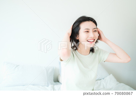 Young beautiful oriental young women at home daily 70080867