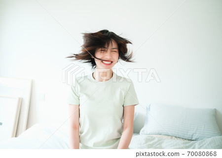 Young beautiful oriental young women at home daily 70080868