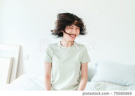 Young beautiful oriental young women at home daily Young beautiful oriental young women at home daily 70080869