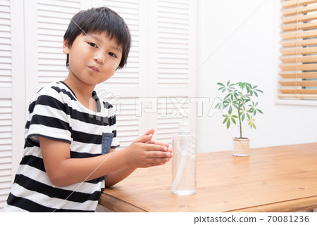 Elementary school boys sanitizing hands Elementary school boys sanitizing hands 70081236