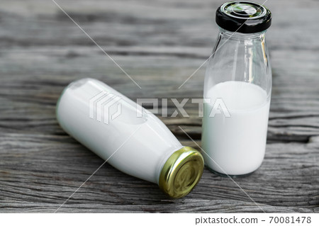 Bottle of fresh milk on an old wood background. 70081478