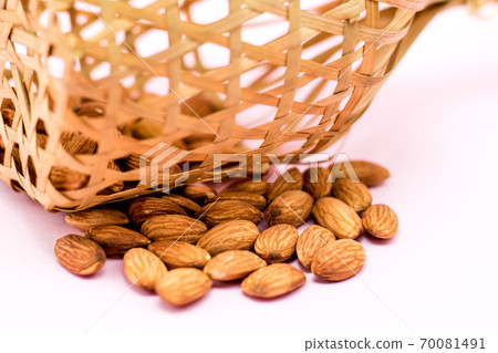 Almonds in round bamboo basket Almonds in round bamboo basket 70081491