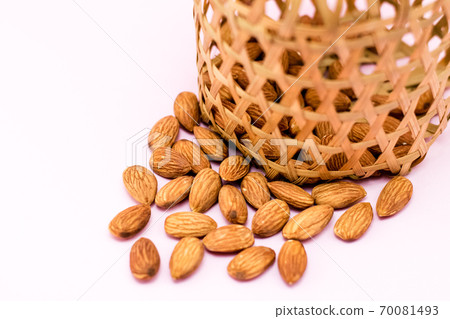 Almonds in round bamboo basket Almonds in round bamboo basket 70081493