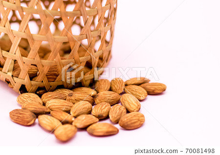 Almonds in round bamboo basket Almonds in round bamboo basket 70081498